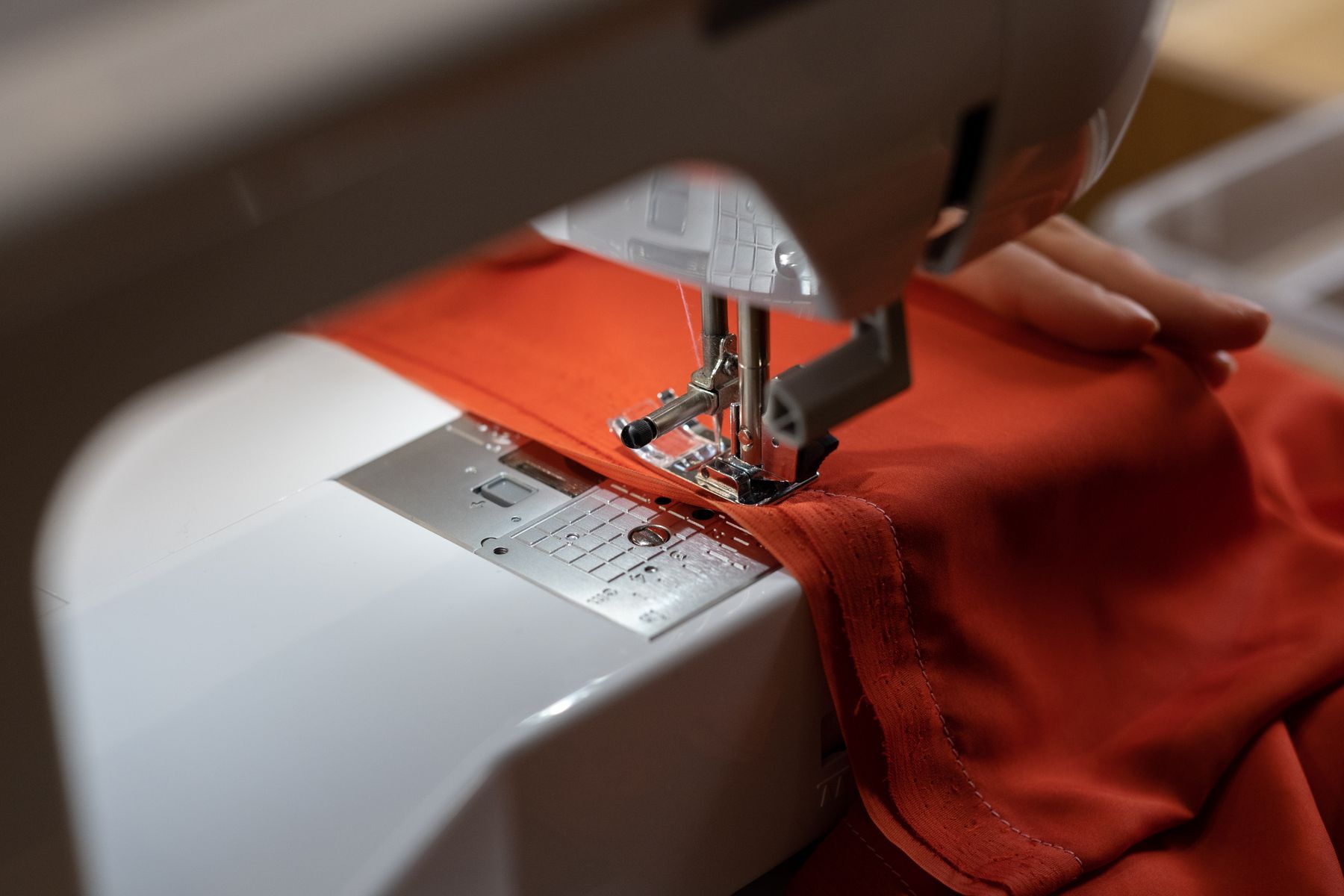 Illustrative detail of fabric being sewn